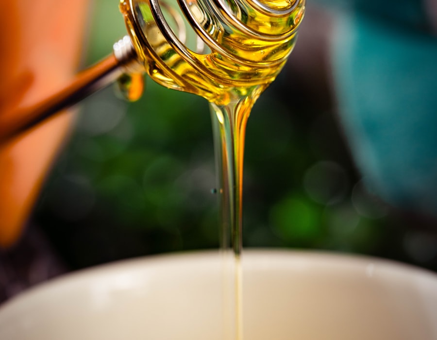 Honey running from a wooden dipper into a bowl