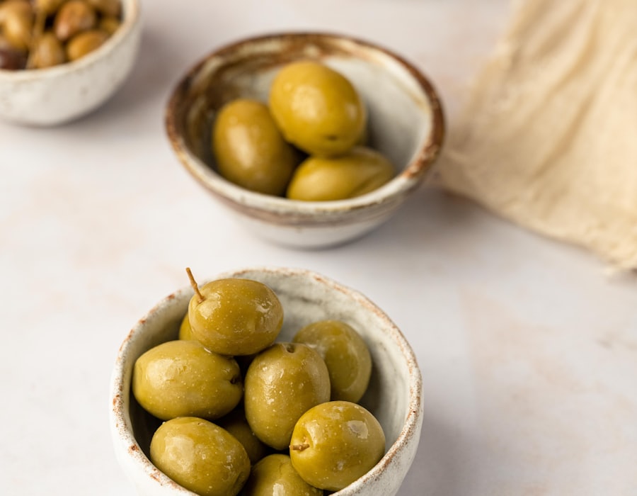 Bowls of green table olives on a linen cloth